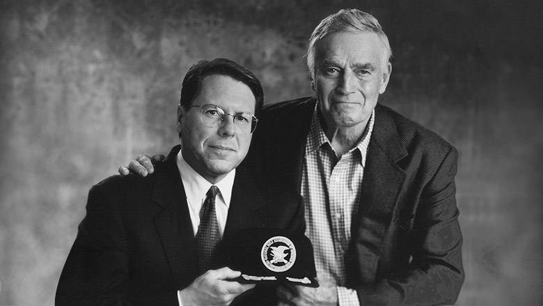 Black and White Photo of Wayne LaPierre and Charlton Heston holding an NRA Cap
