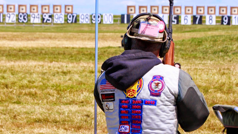Competitive Shooter Looking Downrange at an Outdoor Gun Range