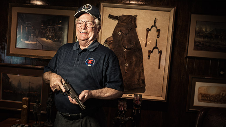 Older NRA Member Proudly Displaying an Antique Pistol