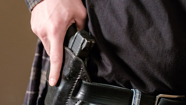 Civilian Drawing Their Firearm from a Concealed Holster