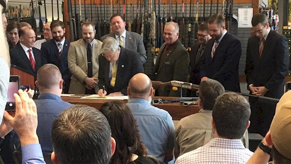 Hunting Legislation being signed at a ceremony.